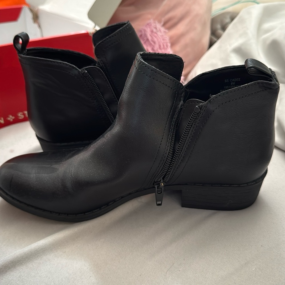 Black ankle high zip up boots.